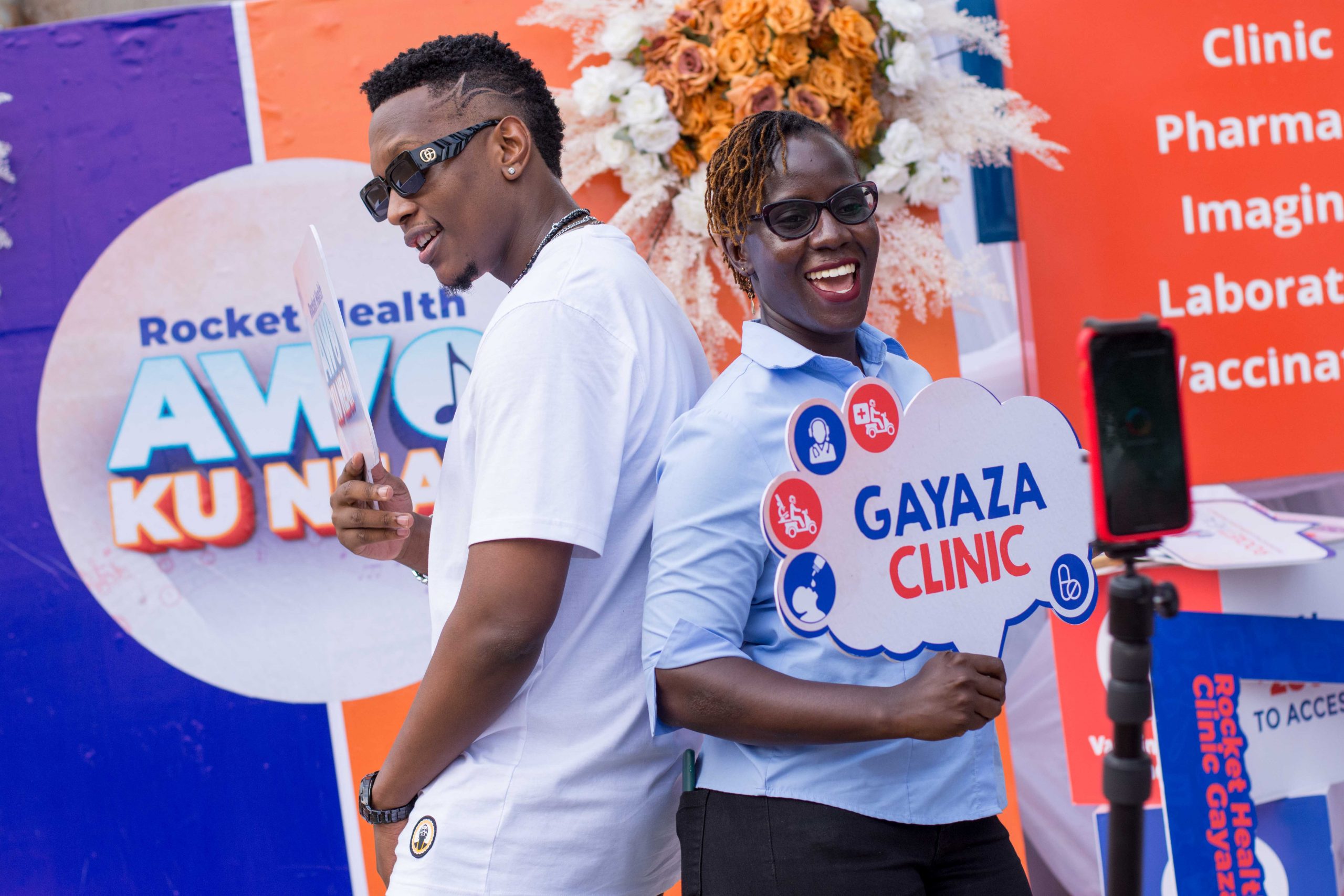 Rocket Health's Sandra Arinaitwe poses with Allan Toniks at launch of Awo Ku Near brand awareness campaign